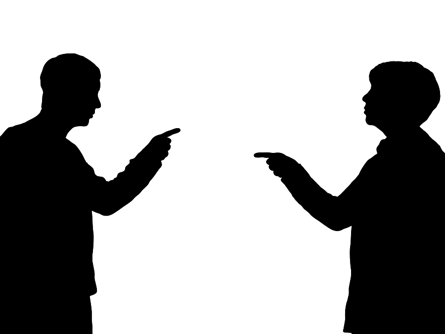 A picture of a man and his partner, each pointing fingers at each other, playing the blame game.