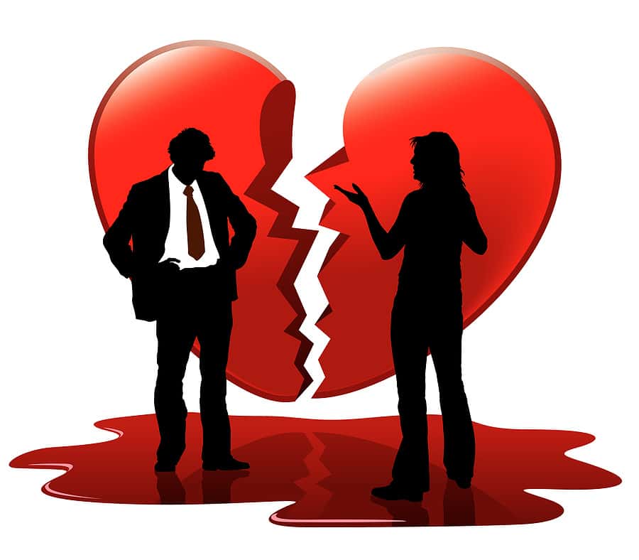 Valentine's Day: Man and woman on opposites sides of a broken heart