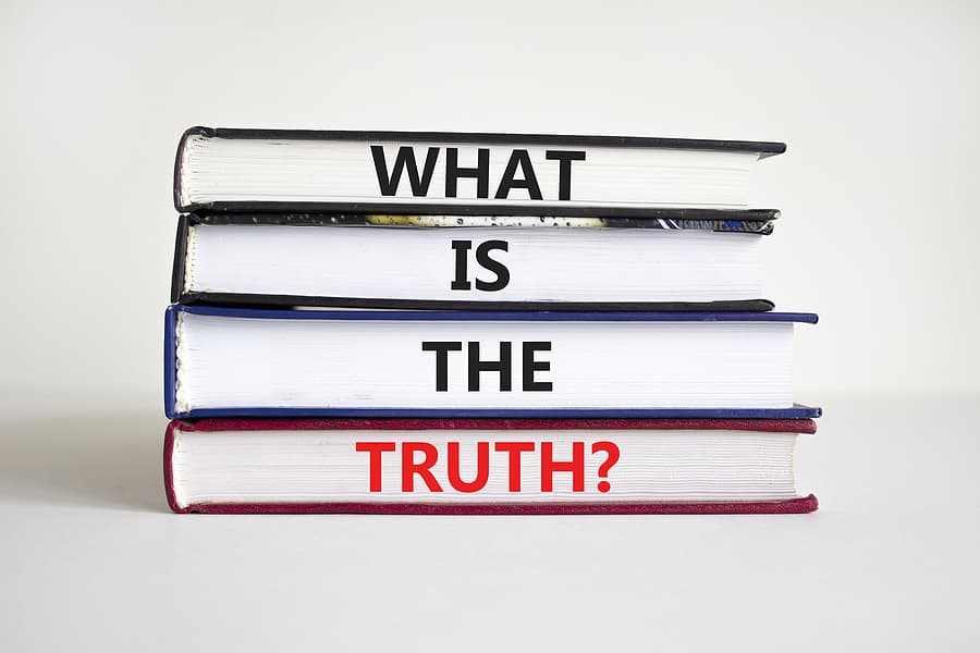 Lies: A stack of 4 boxes marked "what is the truth?" ... one word in the spine of each book.