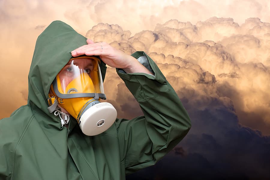 (Gaslighted) woman is wearing a gas mask with a cloud of gas in the background.